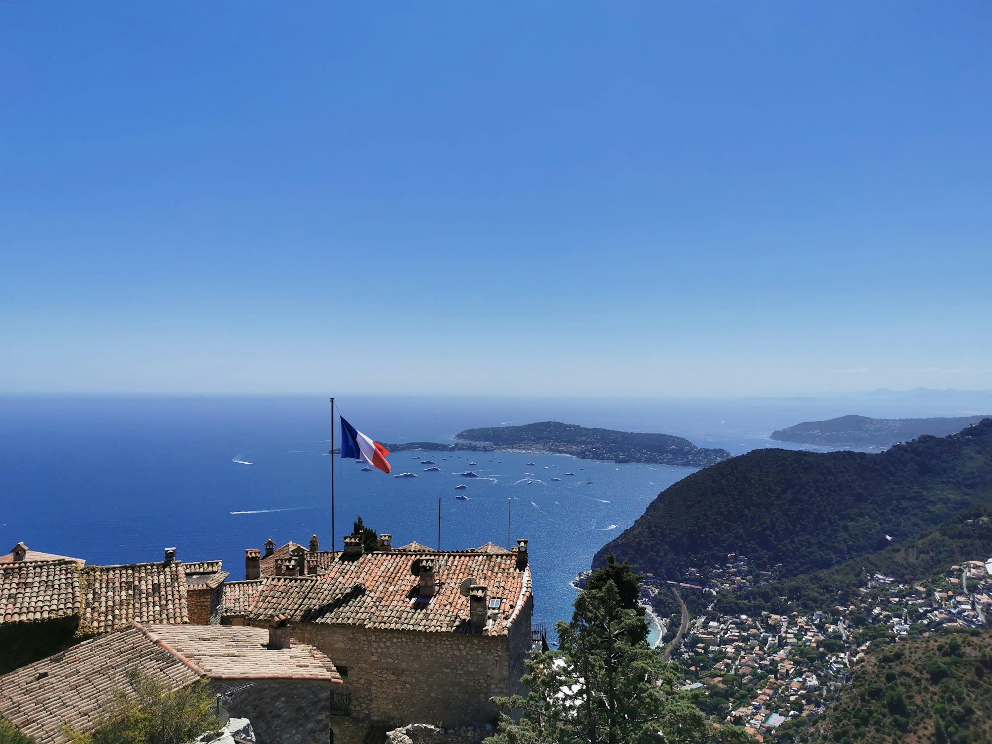 Aerial view of the coastal town with the sea and green hills in the background. Eze, France.